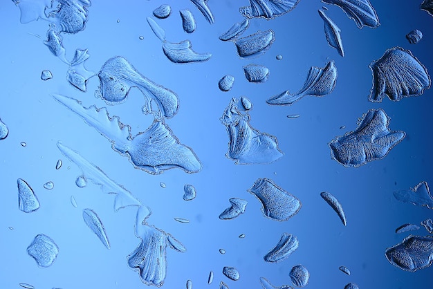 Fondo de vidrio de hielo azul, textura abstracta de la superficie del hielo en el vidrio, agua estacional congelada