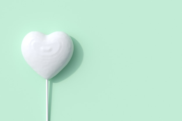 En forma de corazón blanco excepcional de paleta de caramelo sobre fondo verde. Render 3D. Idea mínima del concepto de San Valentín.