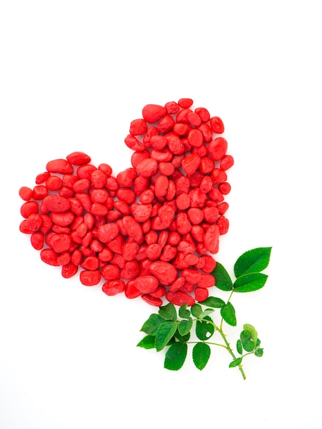 Forma de corazón de piedra roja con hoja de rosa.