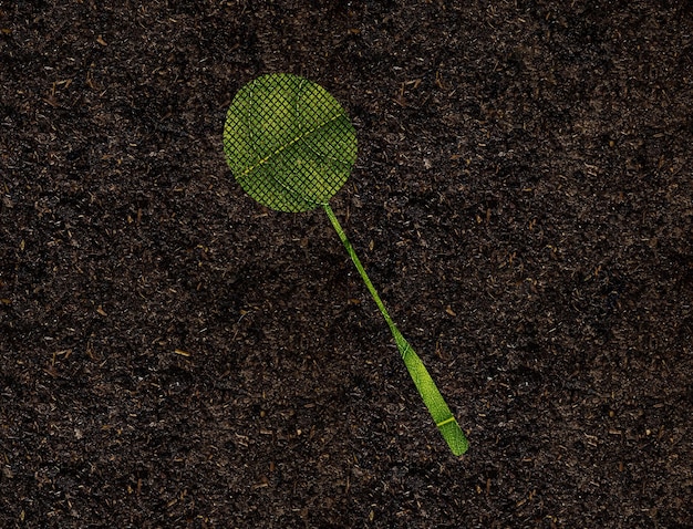 Forma de raqueta de tenis de hojas verdes sobre el concepto de ecología de fondo del suelo