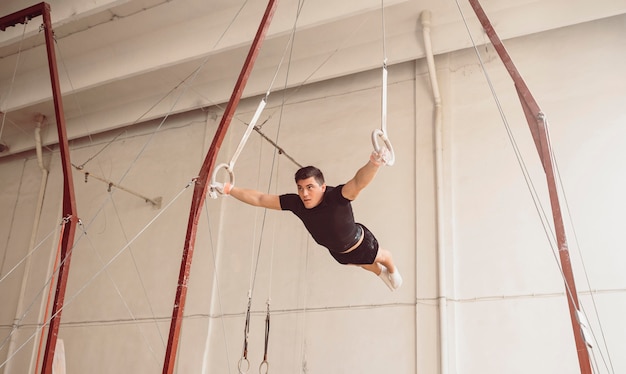 Formación de hombre de tiro largo en anillos de gimnasia