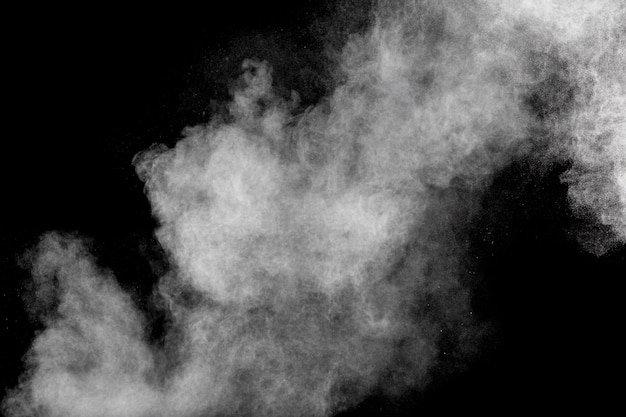 Formas extrañas de la nube de la explosión del polvo blanco contra fondo negro.