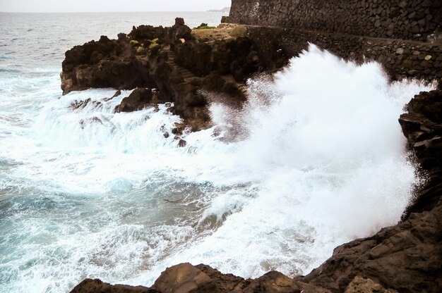 Fortes ondas quebrando na costa vulcânica em Tenerife Ilhas Canárias