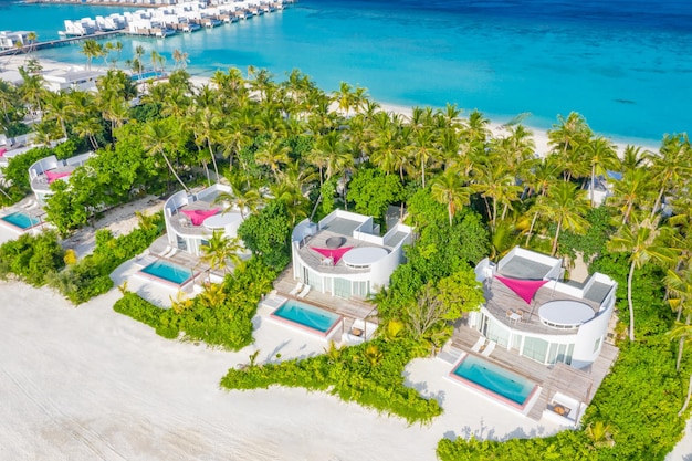 Foto aérea del hermoso paraíso Maldivas villas de playa tropical piscinas con palmeras isla resort