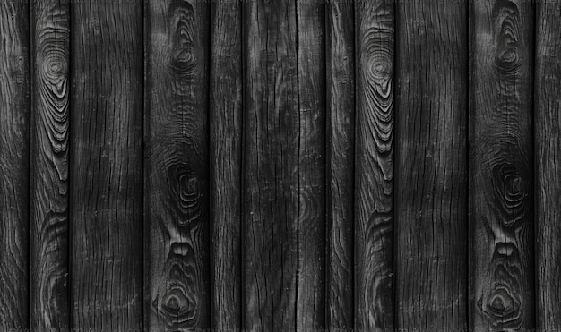 Una foto en blanco y negro de una pared de madera con una superficie rugosa.