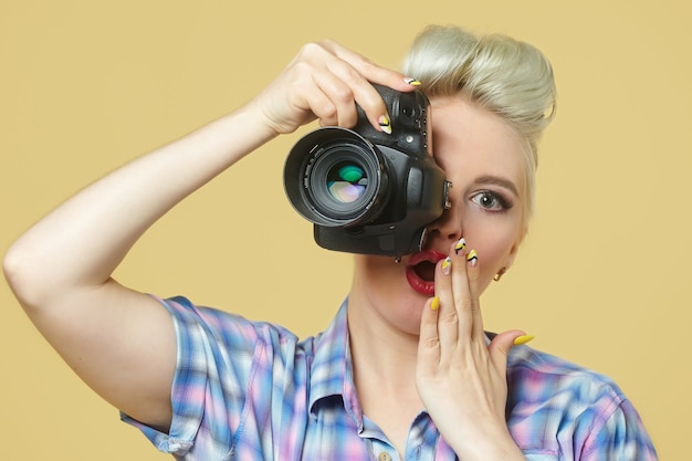 Una foto de la chica pin-up con una cámara de fotos.