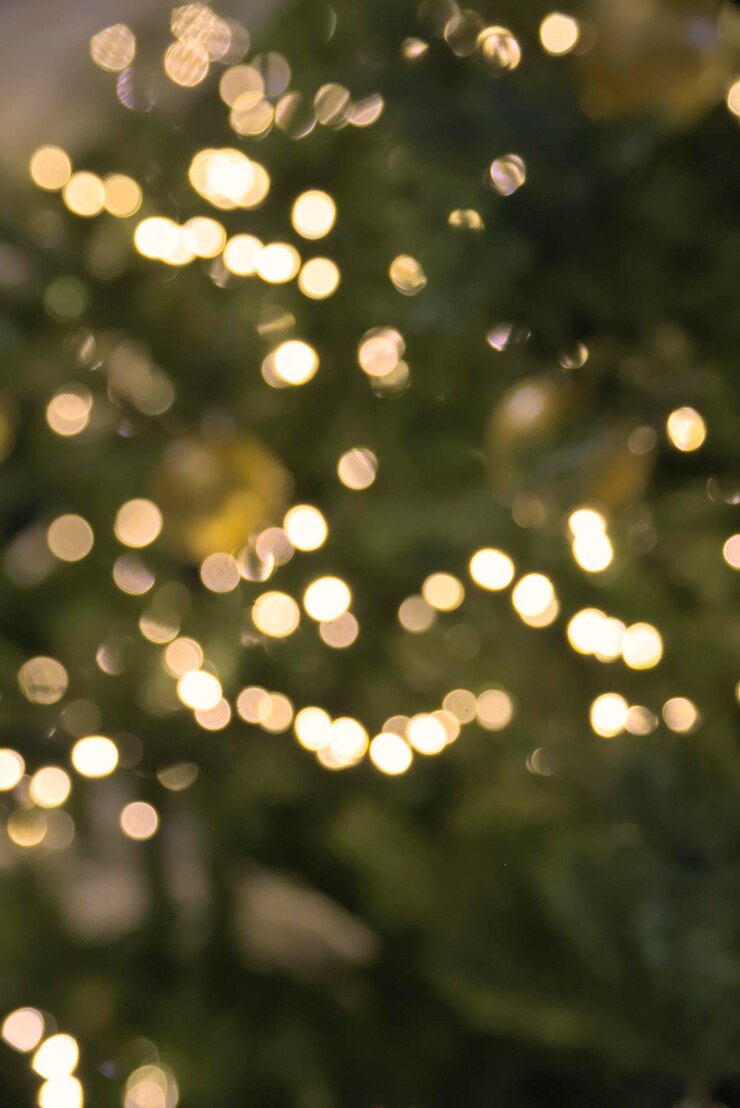 Foto foto conceitual de luzes amarelas quentes de natal com um pano de fundo desfocado de objetos de feriado 2024