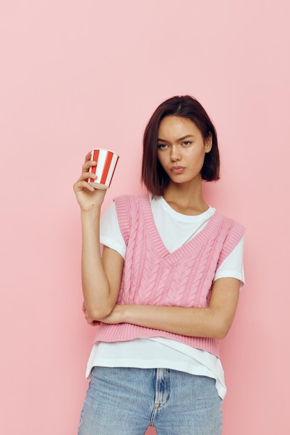 Foto copo descartável de menina bonita em um fundo rosa de camiseta rosa