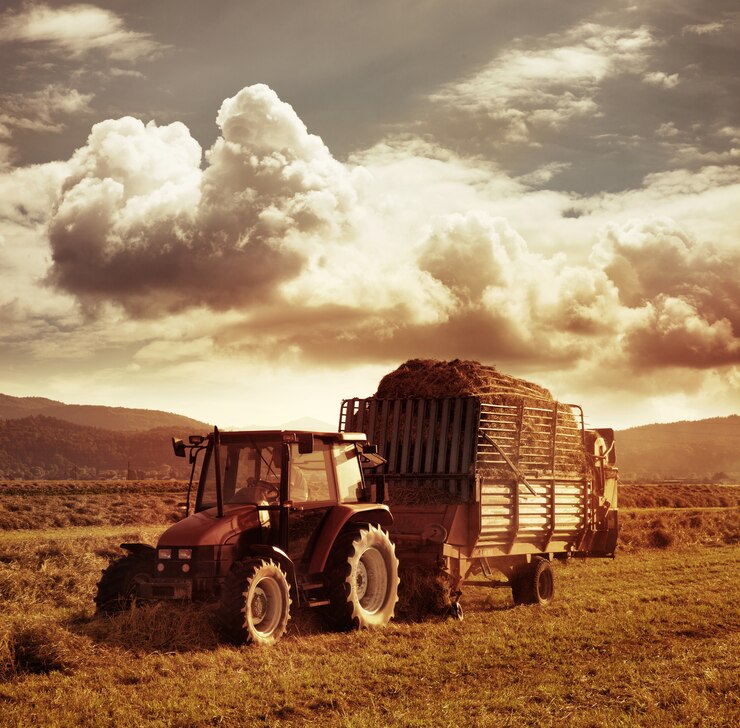 Foto de estilo vintage com trator coletando palha