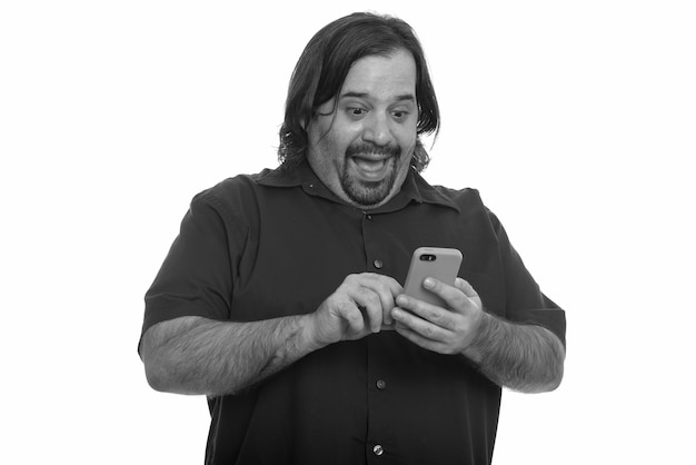 Foto de estúdio de um homem barbudo com excesso de peso isolada contra um fundo branco em preto e branco