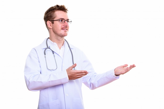 Foto de estúdio de um médico feliz sorrindo enquanto mostra algo