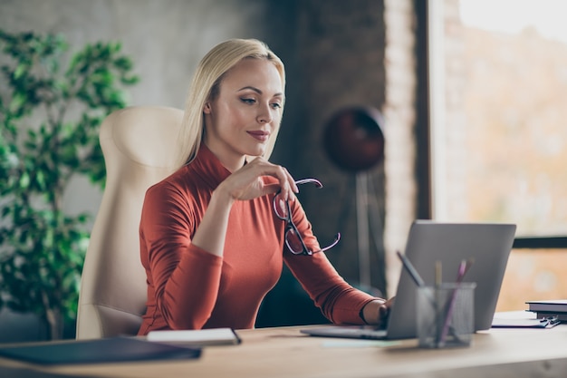 Foto de mulher concentrada e focada comparando analisando possibilidades de crescimento financeiro da empresa neste ano