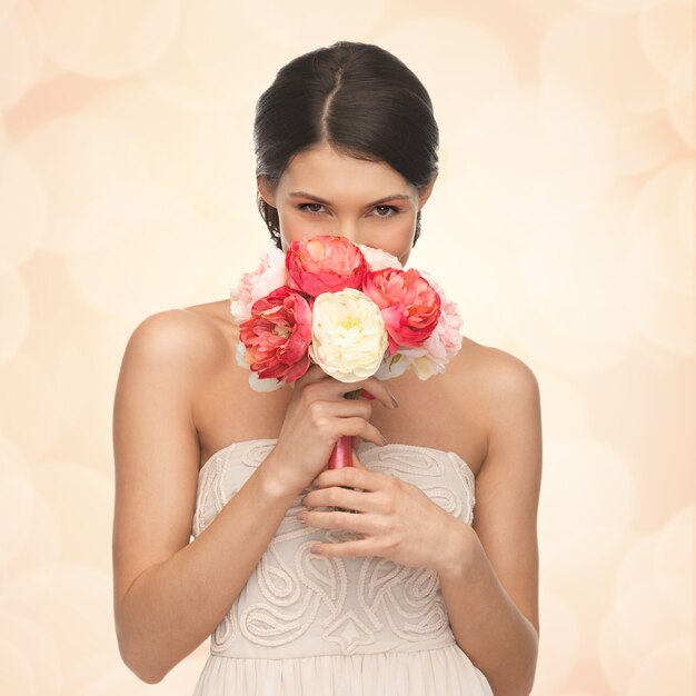 foto de mulher jovem cheirando buquê de flores