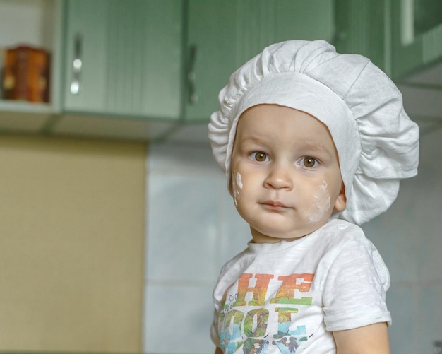 Foto foto de um bebê bonito com um chapéu de chef