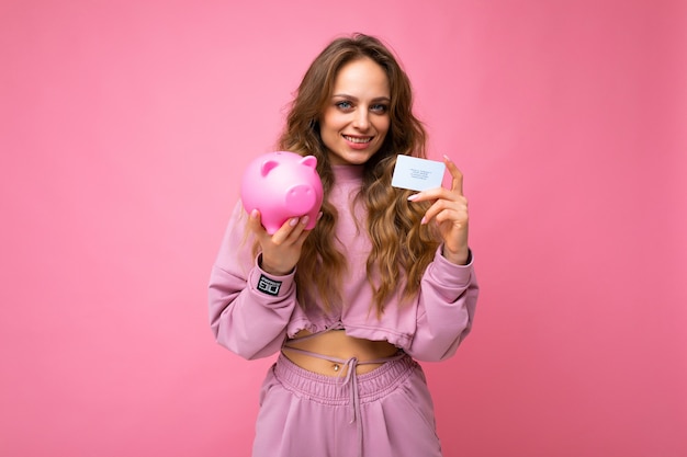 Foto de uma jovem mulher bonita e atraente sorridente positiva, com longos cabelos loiros ondulados com