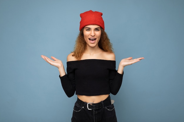 Foto der jungen positiv überraschten schönen brünetten wellenhaarigen Frau mit aufrichtigen Gefühlen tragend