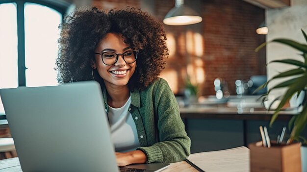 Foto einer schönen lächelnden ethnischen Frau, die von zu Hause aus ferngesteuert am Laptop arbeitet