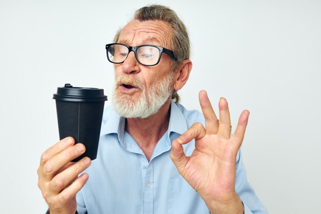 Foto eines alten Mannes im Ruhestand mit Brille und Hemden Einwegglas isolierter Hintergrund