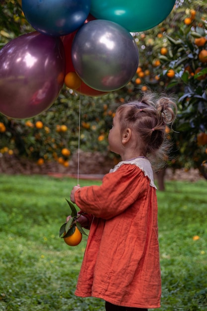 Foto eines Mädchens im Garten zwischen Obstbäumen