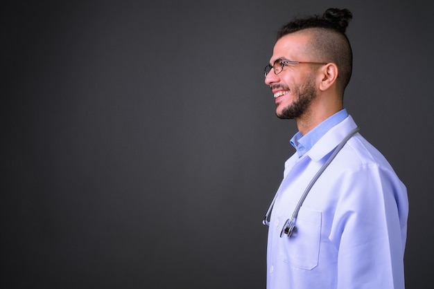 Foto de estudio de guapo médico turco contra un fondo gris