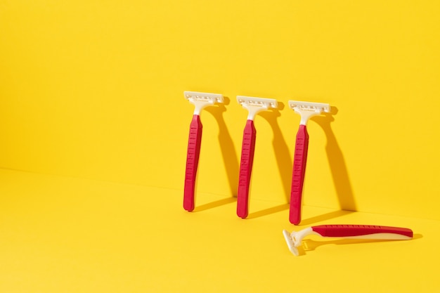 Foto de estudio de herramientas de afeitar desechables en amarillo