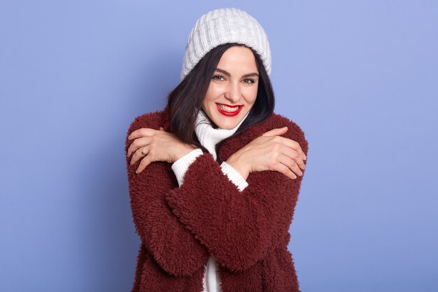 Foto de estudio interior de apuesto alegre joven mujer con cabello negro