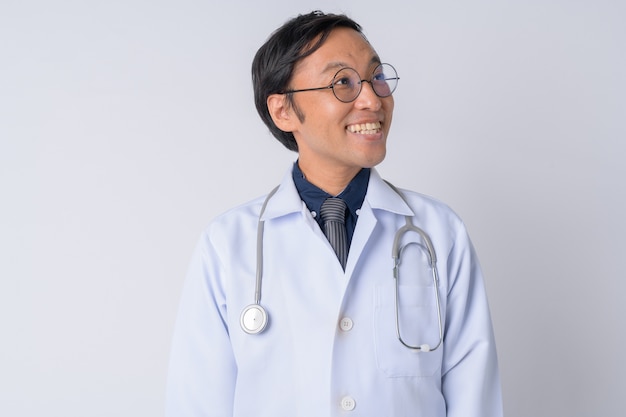 Foto de estudio del médico japonés contra el fondo blanco.