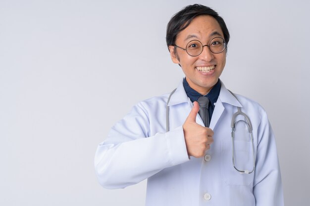 Foto de estudio del médico japonés contra el fondo blanco.