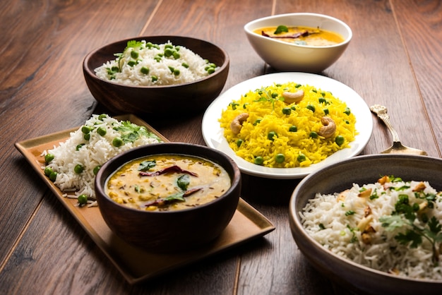 Foto de grupo de arroz indio con guisantes y ajo servido con jeera dal fry, enfoque selectivo