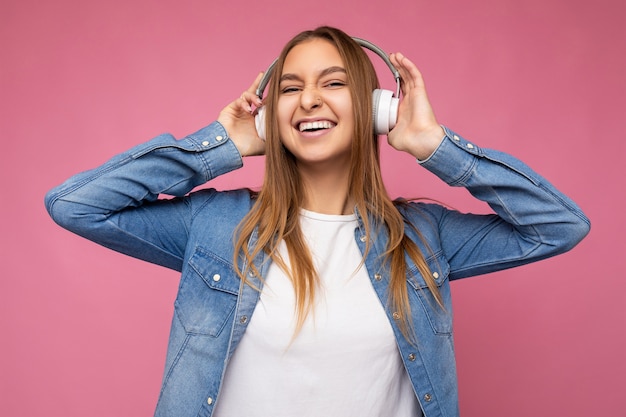 Foto de hermosa mujer rubia joven sonriente feliz vistiendo camisa de mezclilla azul y camiseta blanca