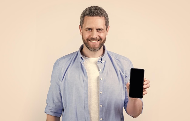foto de un hombre feliz mostrando una aplicación telefónica un hombre mostrando una aplicación telefónica aislado en el fondo del estudio