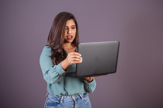 Foto horizontal Hermosa mujer brasileña con ropa casual Jeans y camisa verde con cuaderno
