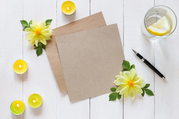 Foto horizontal de hoja de papel en blanco con un lápiz y velas sobre fondo de madera