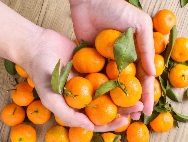 Foto de jugosas mandarinas naranjas desde el ángulo superior plano con mesa de madera