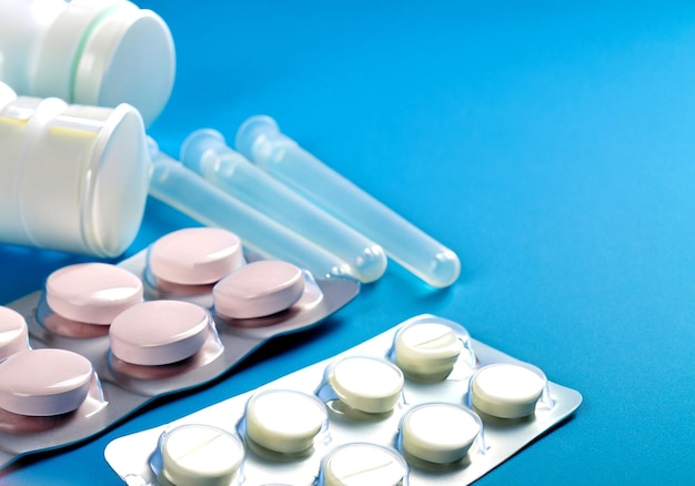 foto de medicamentos suministros médicos colocados sobre un fondo azul