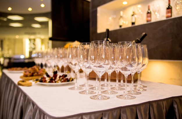 La foto de la mesa está cubierta con aperitivos y copas de vino.