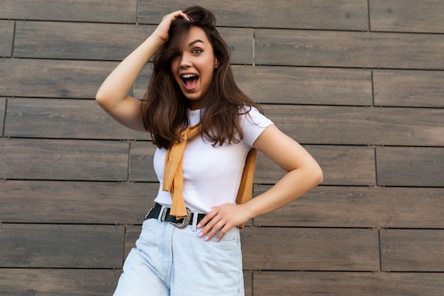 Foto foto de mujer morena bastante joven alegre feliz positiva emocional en traje de moda