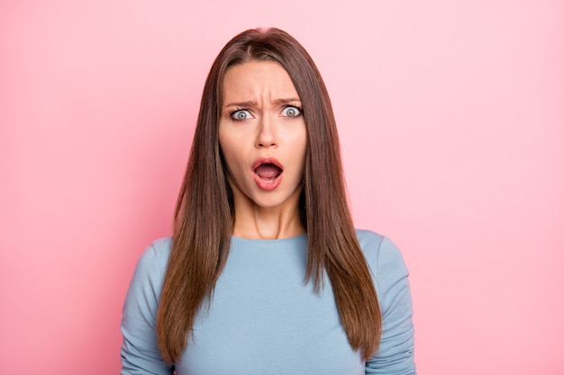 Foto de niña asustada haciendo muecas loca temerosa de las noticias que escuchó emocional aislado sobre fondo de color pastel