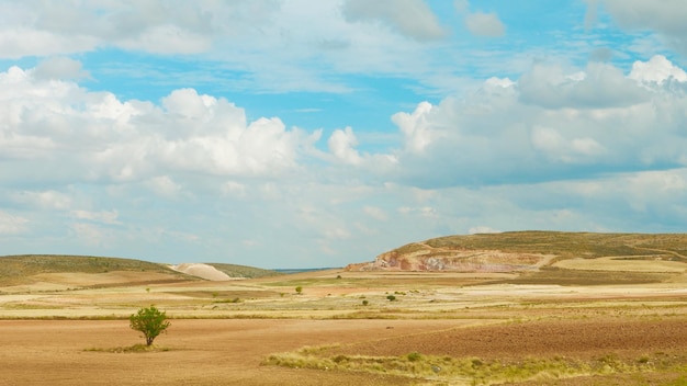 Foto panorámica del majestuoso paisaje nublado sobre tierras agrícolas otoñales secas Teruel Aragón España Tono suave vívido cielo azul de color cian