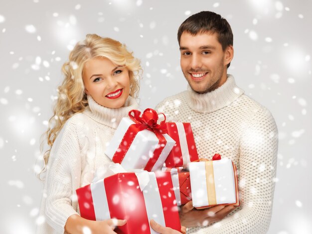 foto de la pareja de la familia en un suéteres con cajas de regalo