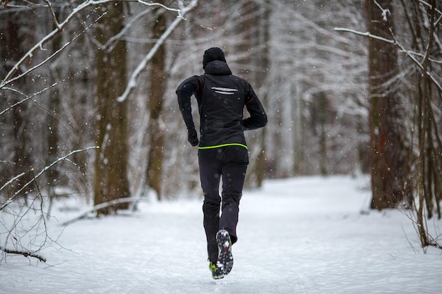 Foto de la parte trasera del atleta corriendo en invierno