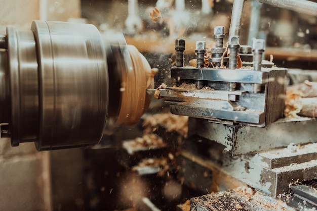 Foto de primer plano de un torno trabajando en madera Procesamiento mecánico de madera