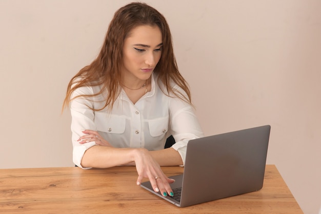 Foto recortada de jovens empreendedoras maduras e inteligentes trabalhando on-line em um laptop