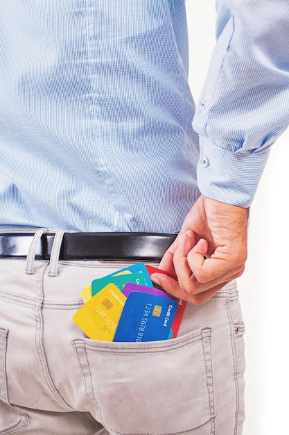 Foto sin rostro de un hombre sacando muchas tarjetas de crédito de su bolsillo, aislado en fondo blanco