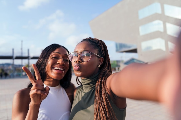 Foto selfie de dos jóvenes amigos negros divirtiéndose en la ciudad, concepto de juventud y amistad, copiando espacio para texto