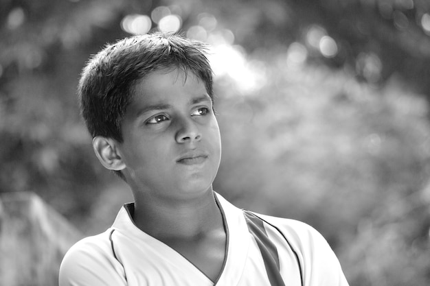 Foto sincera de un joven retrato de niño de cerca la cara mirando a la distancia en blanco y negro