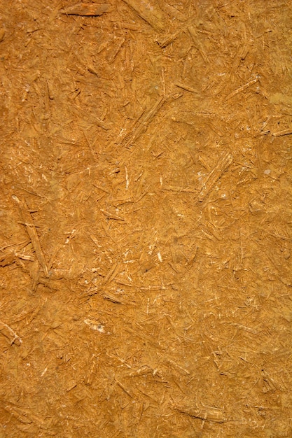 Foto de una vieja textura de tablero de madera naranja compuesta de aserradura de madera