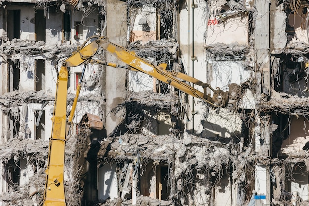 Foto von einem Gebäude, das von einem Bagger abgerissen wird, Close Up Zerstörung eines Hauses, Ruinen, Wiederaufbau