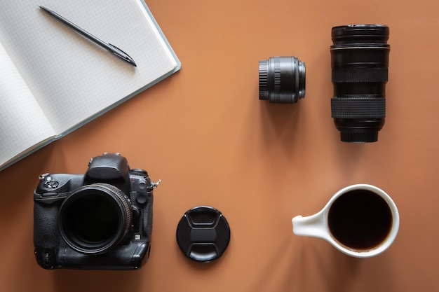 Fotografen-Arbeitsplatz mit Kamera und Objektiv flach liegen