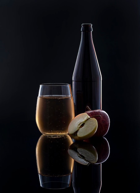 Fotografía de alimentos de la botella de vidrio de sidra de manzana manzanas reflexión de fondo posterior